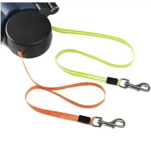 Black retractable dog leash with lime green and orange woven straps, each featuring a black grip section and silver metal clasp.