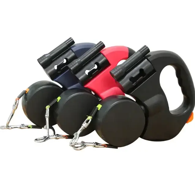 Three retractable dog leashes in navy, red, and black with matching handles and metallic chain attachments.