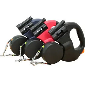 Three retractable dog leashes in navy, red, and black with matching handles and metallic chain attachments.