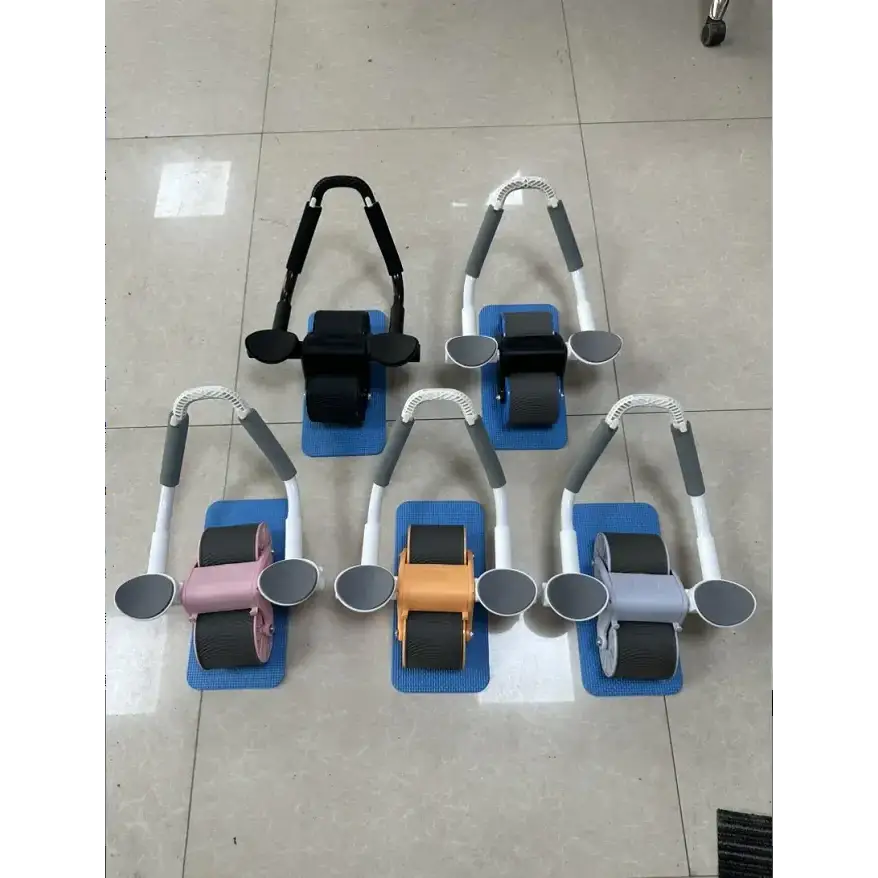 Set of colorful ab roller machines with adjustable handles and rubber wheels on blue mats.