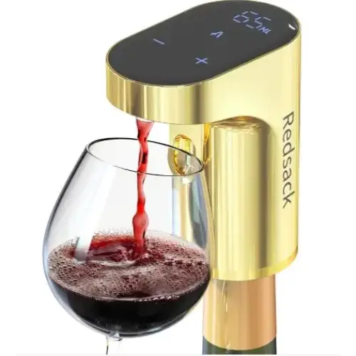 Gold-colored redstack wine aerator pouring red wine into a glass.