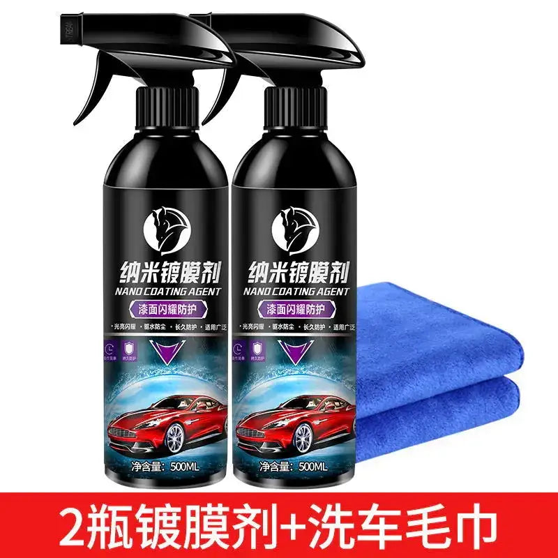 Two black spray bottles of nano coating agent with red and white labels featuring a sports car image, accompanied by two folded blue microfiber towels.