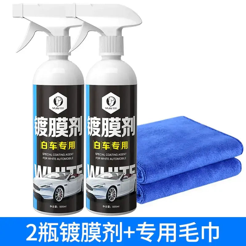 Two white spray bottles of vju brand special coating agent for white automobiles, each 500ml, accompanied by a folded blue microfiber cloth.