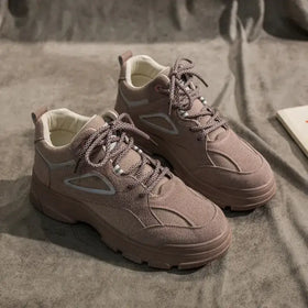 Beige suede high-top sneakers with mesh panels and chunky rubber soles.