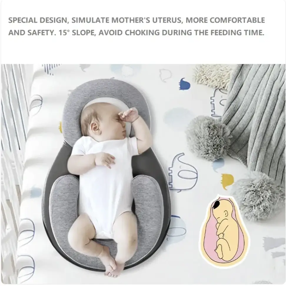 Gray and black ergonomic baby sleep positioner designed to simulate a mother’s uterus for safe, comfortable feeding positioning.