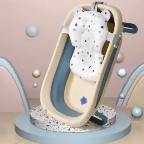 Beige and blue foldable baby bathtub with a white star-patterned cushion.