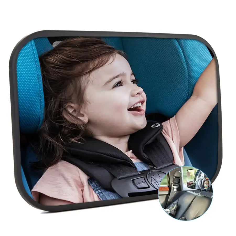 Black-framed rectangular car rearview mirror with a child in a blue seatbelt harness smiling.