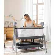 Gray and white convertible baby bassinet with mesh sides, metal frame, and storage shelf below.