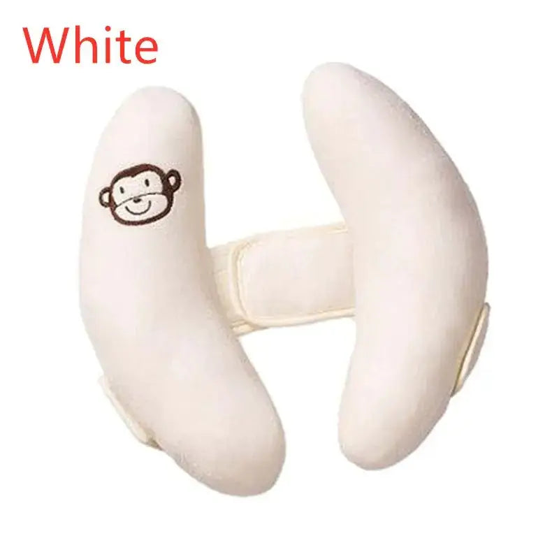 White plush monkey-themed neck pillow with soft fabric and a simple embroidered face.