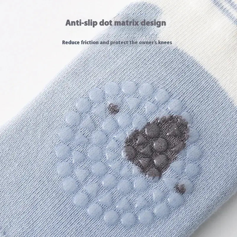 Light blue knee pad with an anti-slip dot matrix design featuring a pattern of raised, translucent dots and darker textured patches for grip.
