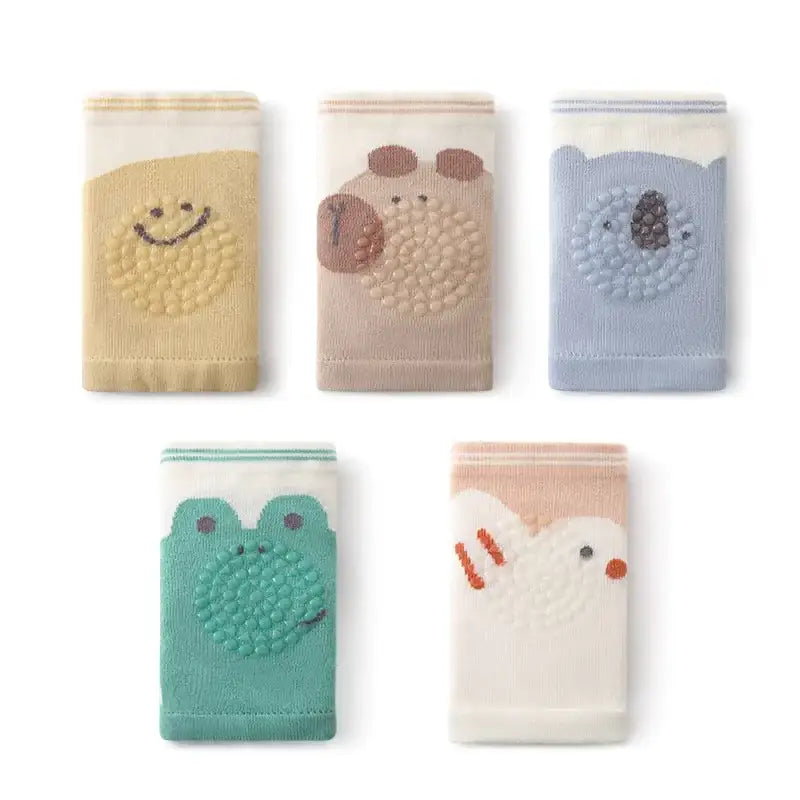 Set of five soft, plush baby socks featuring embroidered animal faces in pastel colors like beige, pink, blue, and green.