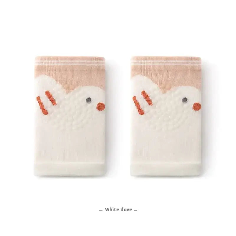 A pair of soft, cream-colored knit socks featuring embroidered white dove designs with orange beaks and feet.
