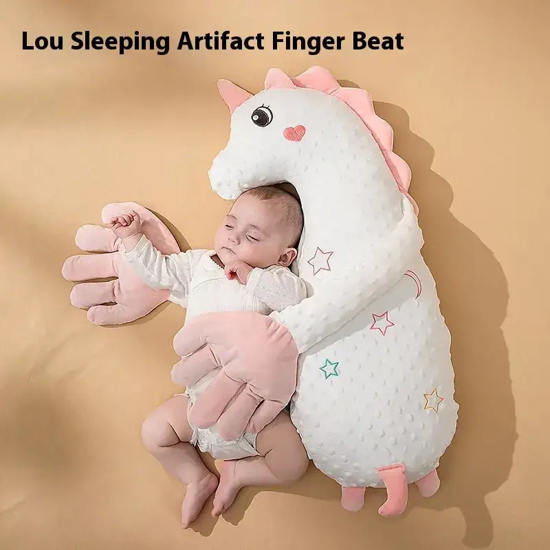 A plush unicorn-shaped sleeping aid with pink accents and embroidered stars, designed for baby comfort.