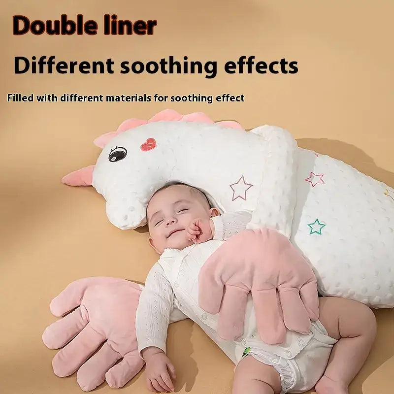 White unicorn-shaped baby pillow with pink accents and star embroidery, featuring a double-liner design for soothing effects.