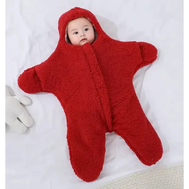 Red star-shaped baby onesie made of plush, soft fabric with a hood and zipper front.