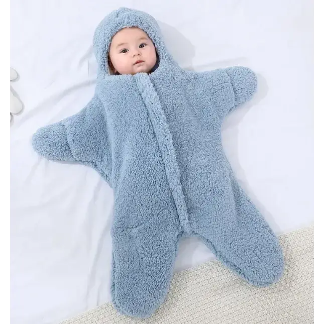 A soft, light blue star-shaped baby sleeper made of plush fleece material with a hood and zipper front.