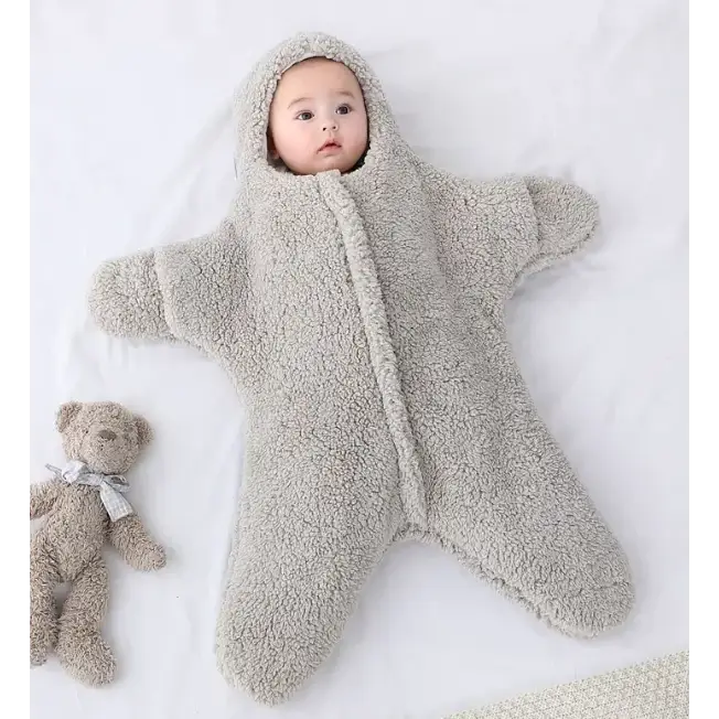 A soft, light gray star-shaped baby sleeper made of plush fleece material with a hood and zipper down the front.