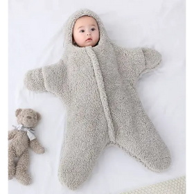 A soft, light gray star-shaped baby sleeper made of plush fleece material with a hood and zipper down the front.