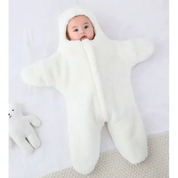 A soft, white, plush star-shaped baby onesie with a hood and attached feet.
