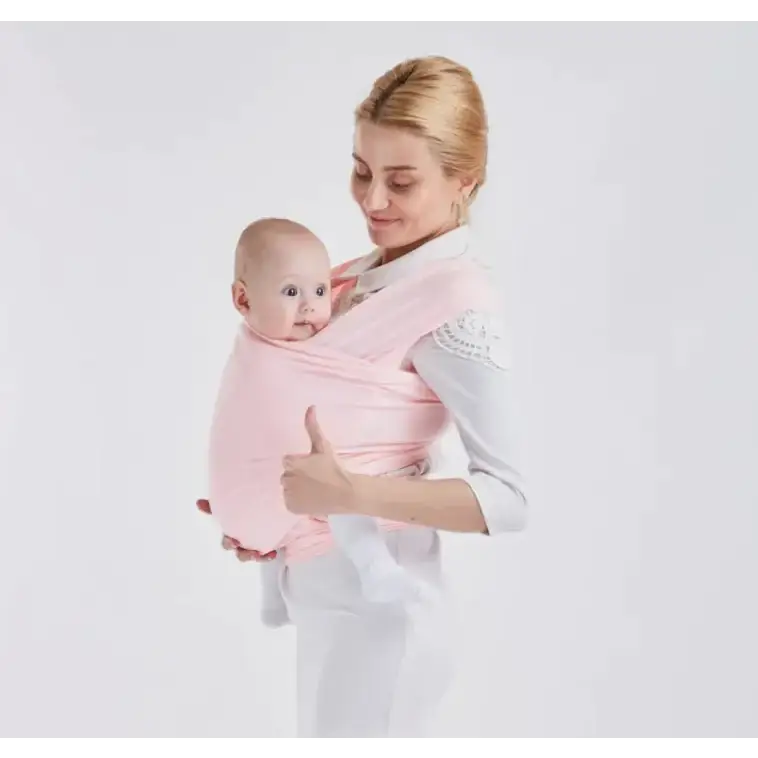 Soft pink fabric baby wrap securely cradling a newborn.
