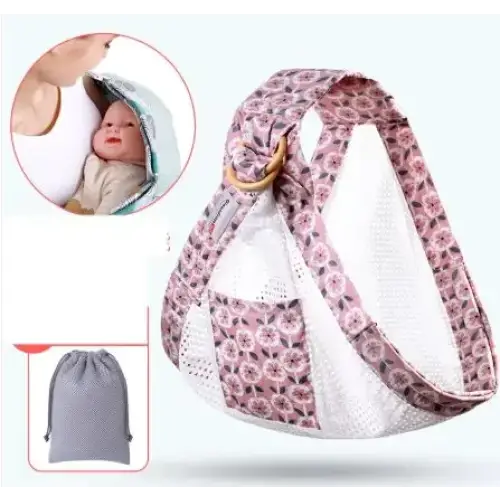 Pink floral-patterned baby carrier with mesh panels and a wooden ring buckle.