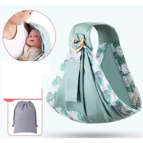 A soft mint-green baby sling with a leaf-patterned trim and wooden ring for secure carrying.