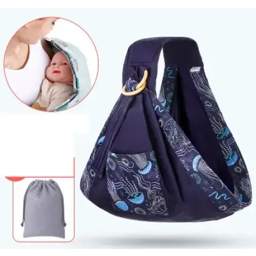 Navy blue baby sling with a pattern of light blue and white oceanic designs, featuring adjustable straps and a matching drawstring storage bag.