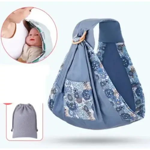 Blue patterned baby sling with floral fabric accents and a wooden ring.