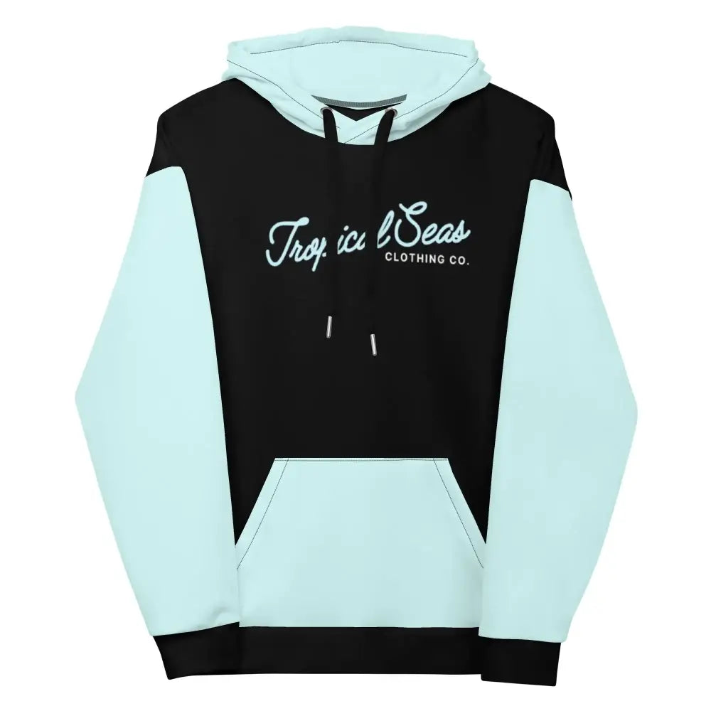 A black and light blue color-blocked hoodie with a cuffed hem, featuring the ’tropical seas clothing co.’ logo in white script across the chest.