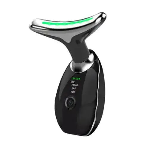 Black and silver facial massage device with a glowing green light strip on the head.