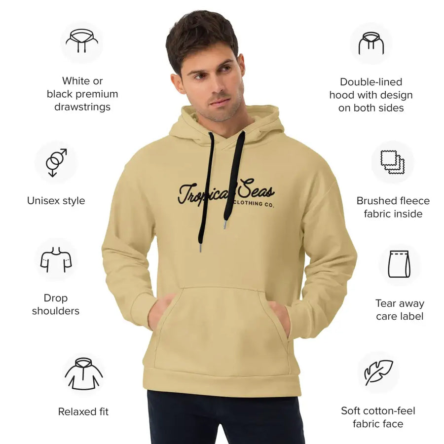 Beige unisex hoodie with black drawstrings and a ’tropical seas clothing co.’ logo in cursive script across the chest.