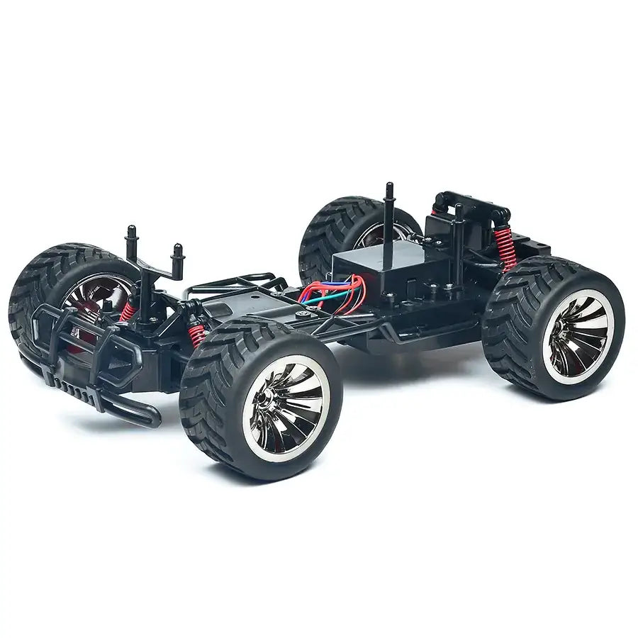 Black remote-controlled monster truck chassis with chrome-finished multi-spoke wheels and red coil springs.