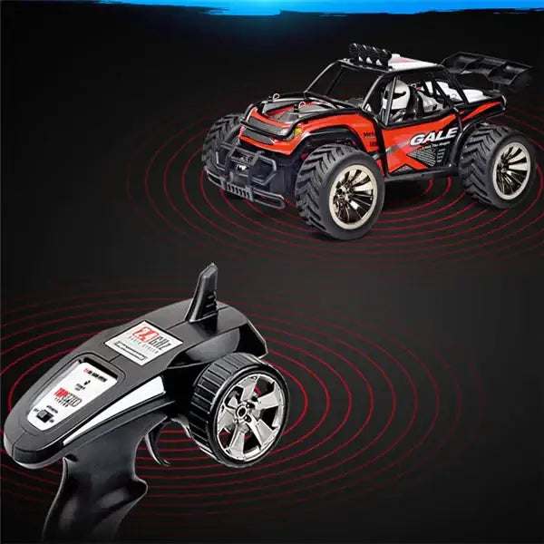 Red and black remote-controlled monster truck with silver alloy wheels.