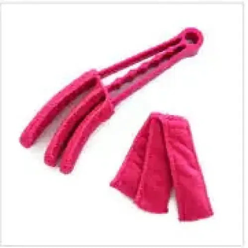 Pink silicone cleaning tool with three flexible prongs and a looped handle.