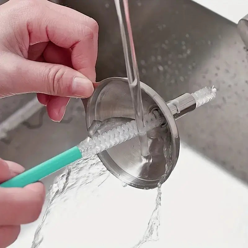 A stainless steel funnel with a built-in brush attachment, designed for cleaning narrow openings.