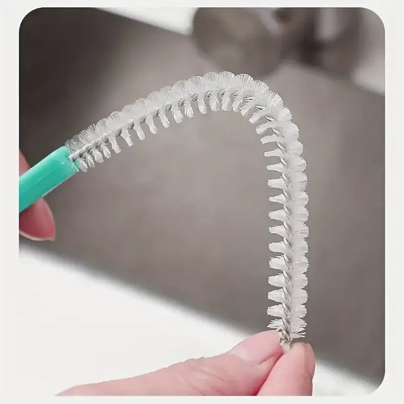 A teal-handled bottle brush with white bristles forming a curved, flexible cleaning head.
