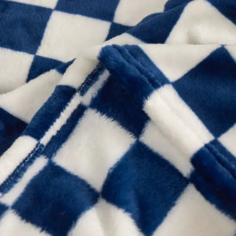 Blue and white diamond-patterned plush blanket.