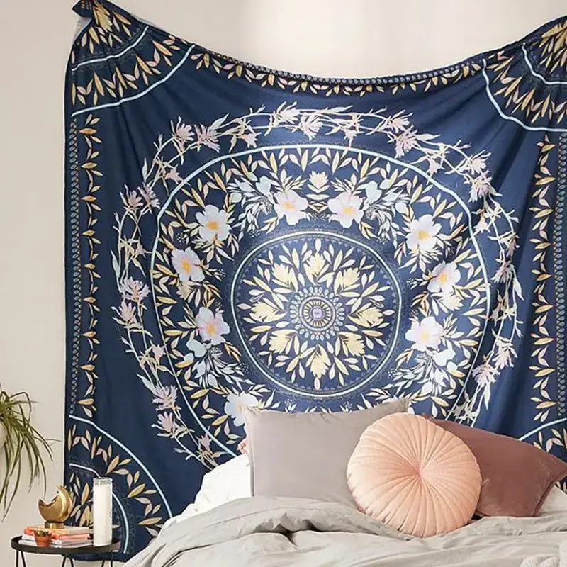 A navy blue mandala tapestry with intricate floral patterns in white and gold, featuring a central circular design surrounded by concentric rings of blossoms.