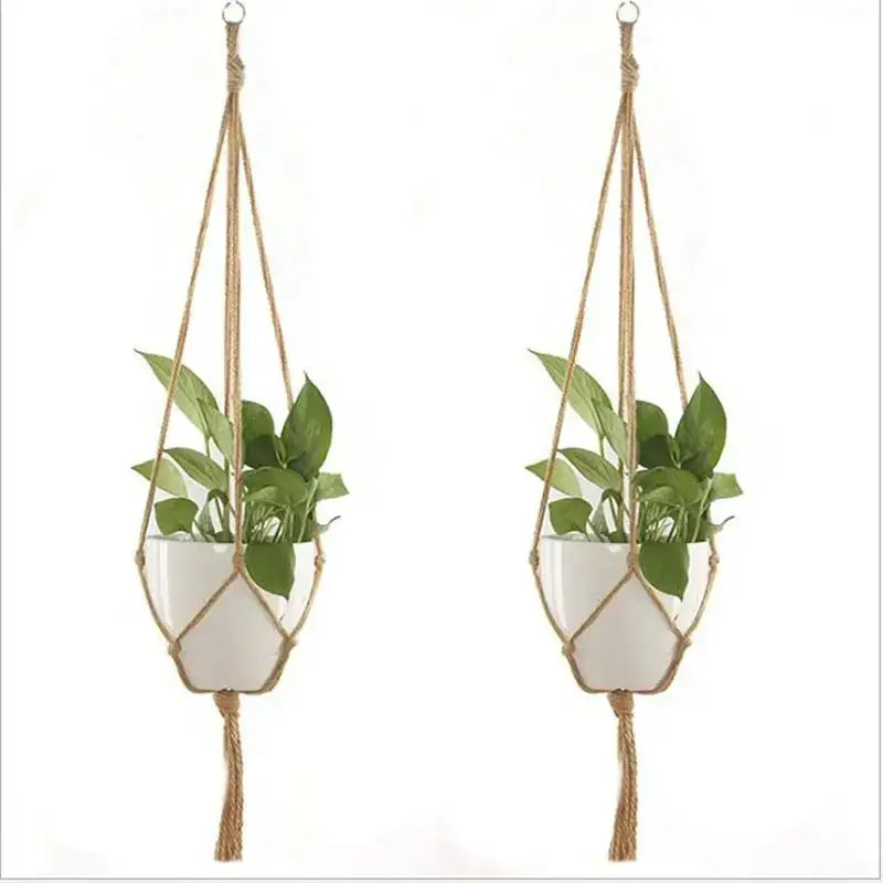 Natural fiber macrame plant hangers with white ceramic pots.