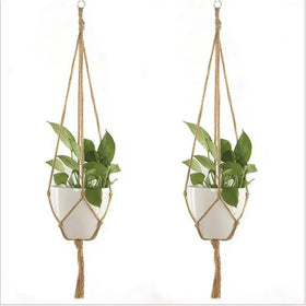 Natural fiber macrame plant hangers with white ceramic pots.