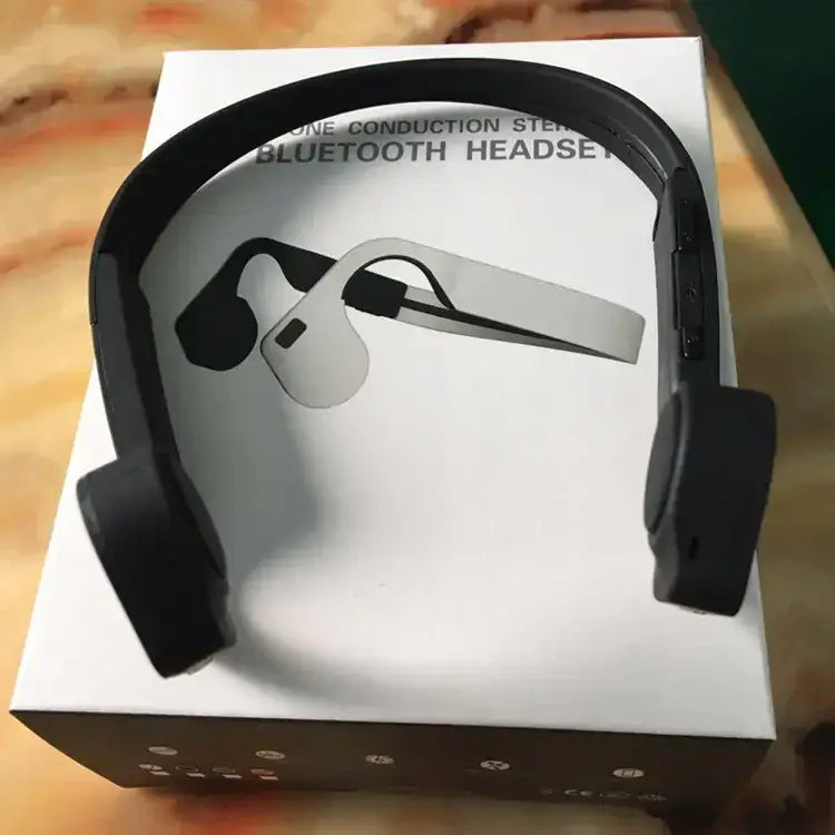 Black bone conduction bluetooth headset with sleek, minimalist design and matte finish.