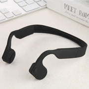 Black silicone bone conduction headphones with a sleek, minimalist design.
