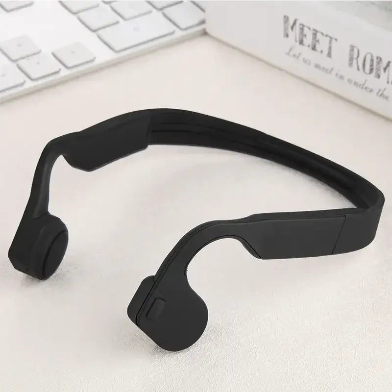Black silicone bone conduction headphones with a sleek, minimalist design.