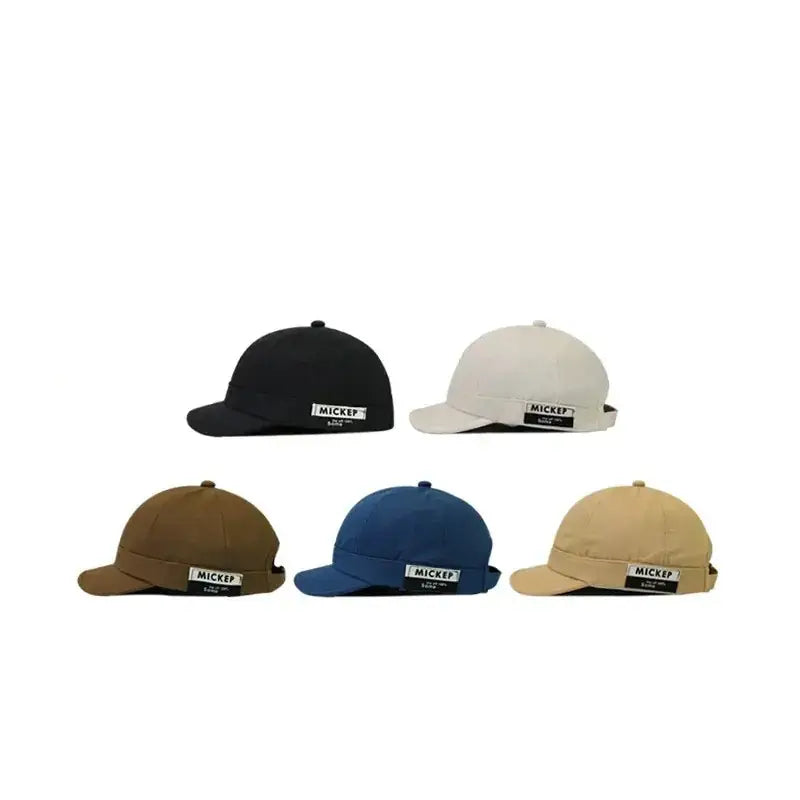 Five mickep brand baseball caps in black, off-white, brown, blue, and beige.