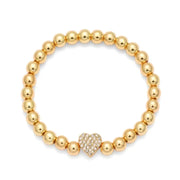 Gold-toned beaded bracelet featuring a central heart charm adorned with sparkling clear crystals.