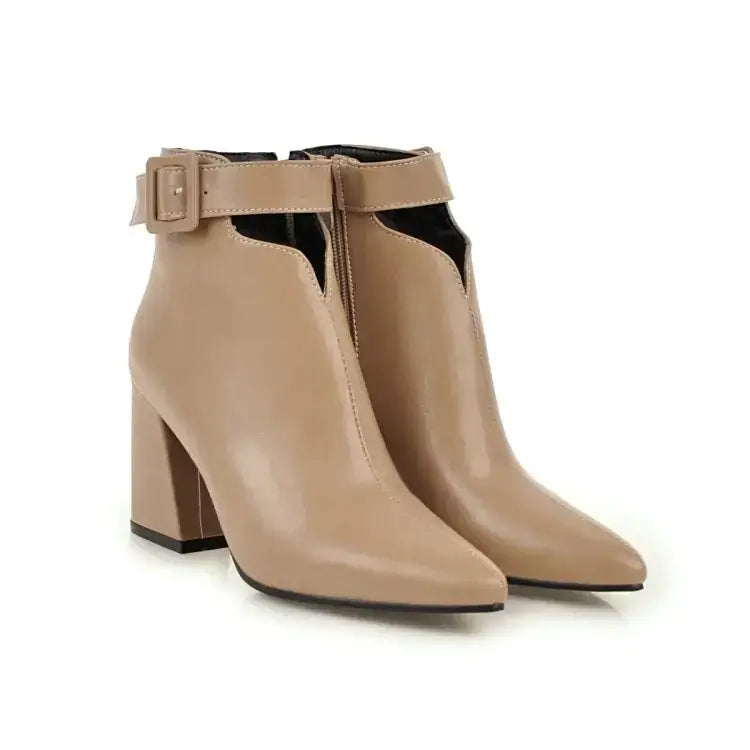 Beige patent leather ankle boots with a block heel and adjustable strap.