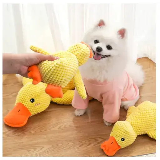 Yellow crocheted duck toy with orange beak and feet.