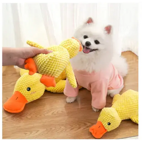 Yellow crocheted duck toy with orange beak and feet.