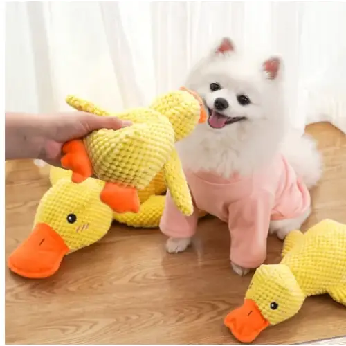 Yellow crocheted duck toy with orange beak and feet.