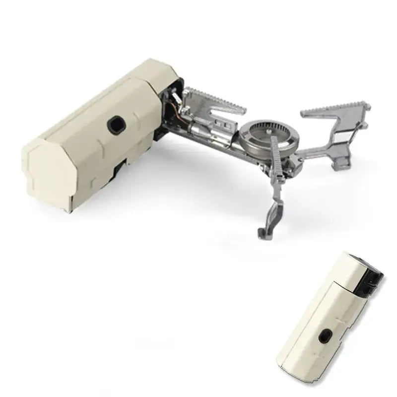 Beige and silver portable camping stove with foldable legs and a detachable fuel canister.